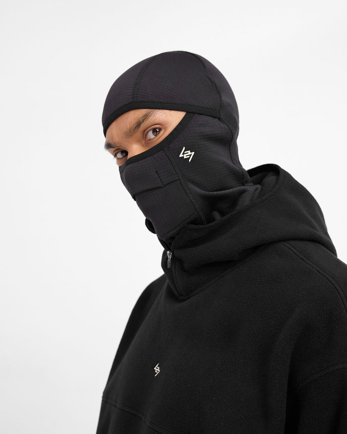 Front product image of a mens black balaclava on a plain white background | 247 Balaclava in Black | Gridded fleece balaclava with ventilation and branding | 247 Accessories | Represent Clo