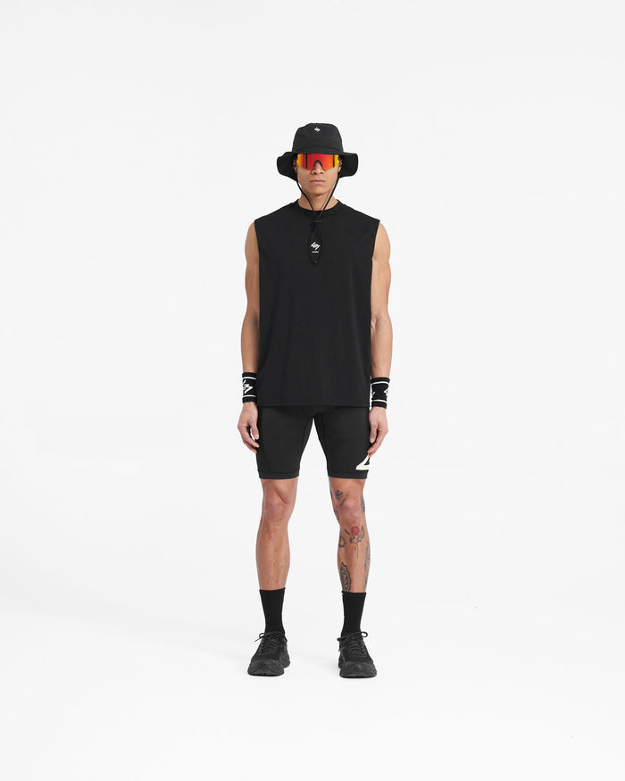 Man wearing black cargo half tights on a plain white background | 247 Cargo Half Tight in Jet Black | Training shorts with stretch ripstop paneling | 247 Shorts | Represent Clo