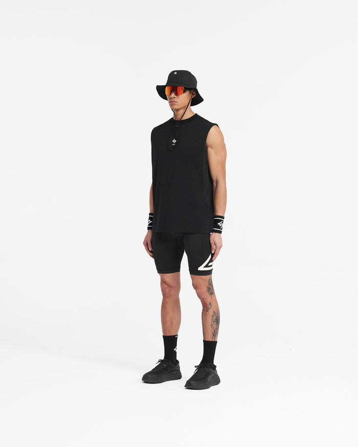Man wearing black cargo half tights on a plain white background | 247 Cargo Half Tight in Jet Black | Training shorts with stretch ripstop and silicone grips | 247 Shorts | Represent Clo