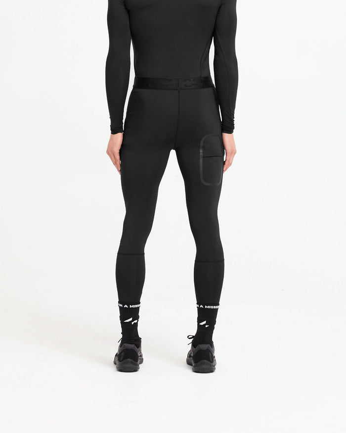 Man wearing black leggings on a plain white background | 247 Compound Legging in Black | Full length leggings with branded waistband and quick drying technology | 247 Pants | Represent Clo
