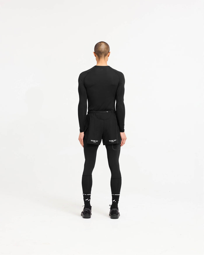 Man wearing black leggings on a plain white background | 247 Compound Legging in Black | Full length leggings with branded waistband and phone pocket | 247 Pants | Represent Clo
