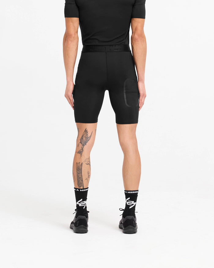Man wearing black legging shorts on a plain white background | 247 Compound Legging Short in Black | Legging shorts with elasticated waistband and pocket | 247 Shorts | Represent Clo