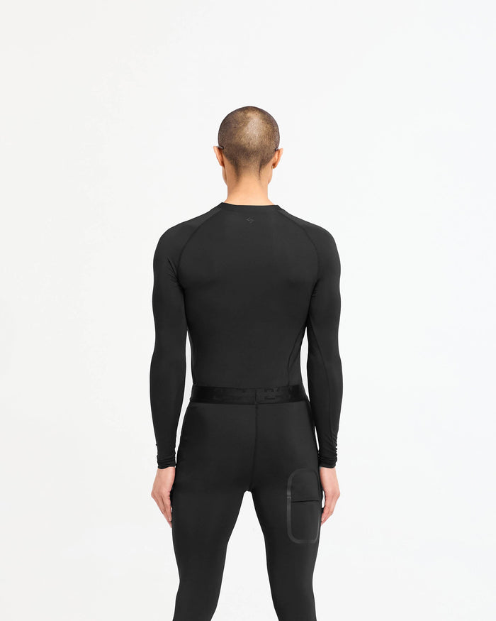 Man wearing a black long sleeve t-shirt on a plain white background | 247 Compound Long Sleeve T-Shirt in Black | Antibacterial quick drying t-shirt with raglan sleeves | 247 T-Shirts | Represent Clo