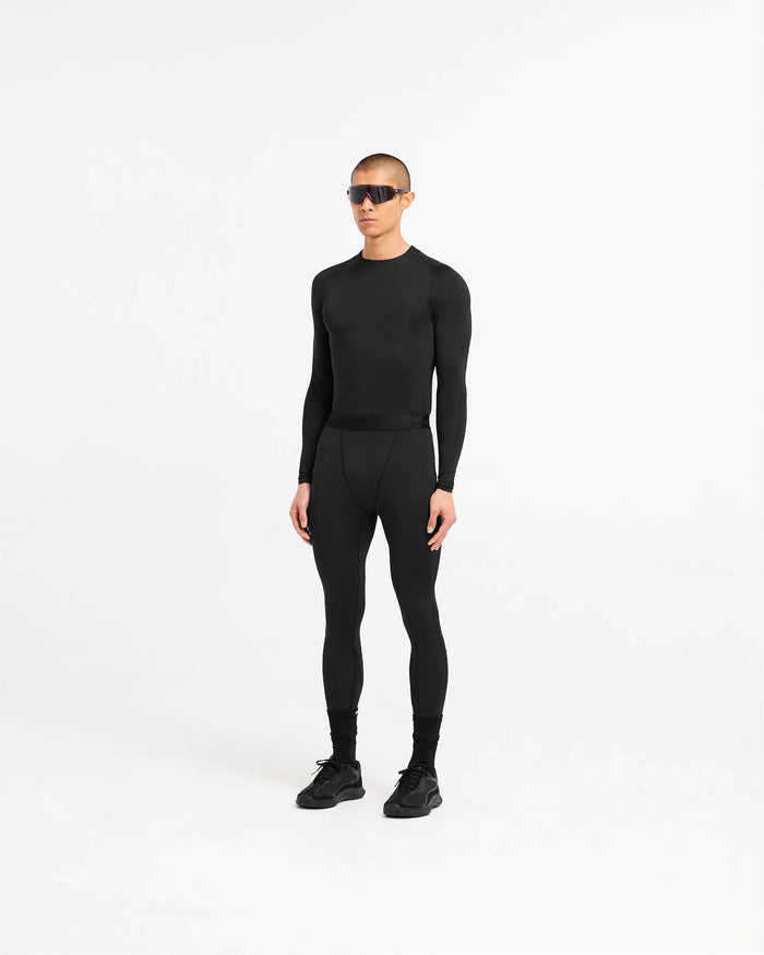 Man wearing a black long sleeve t-shirt on a plain white background | 247 Compound Long Sleeve T-Shirt in Black | Long sleeve raglan t-shirt with 4-way stretch | 247 T-Shirts | Represent Clo