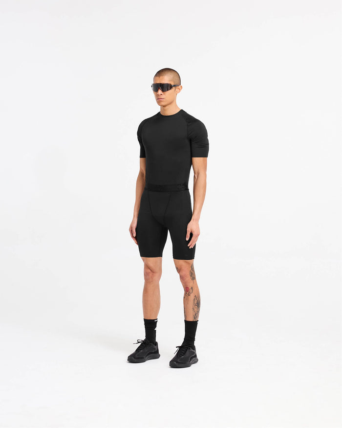 Man wearing a black t-shirt on a plain white background | 247 Compound T-Shirt in Black | Raglan sleeves and 4-way stretch t-shirt | 247 T-Shirts | Represent Clo