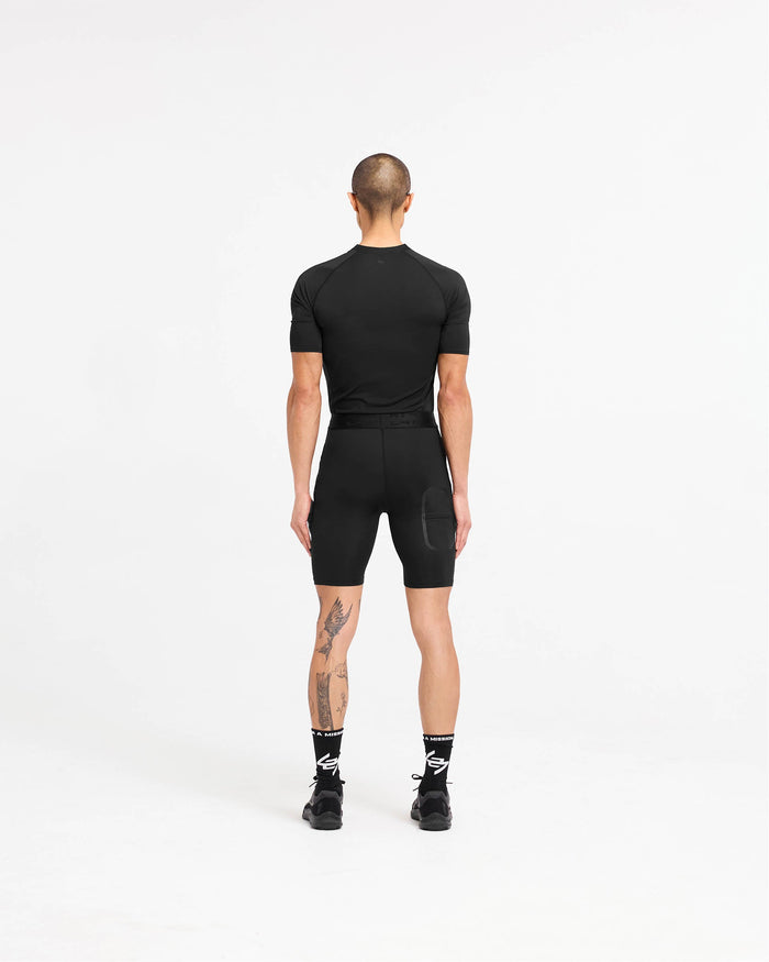 Man wearing a black t-shirt on a plain white background | 247 Compound T-Shirt in Black | T-Shirt with raglan sleeves and external flatlock stitching | 247 T-Shirts | Represent Clo