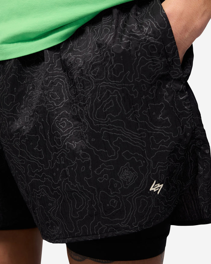 Man wearing black running shorts and leggings on a plain white background | 247 Contour 2-In-1 Run Shorts in Black | Running shorts with reflective contour print and zip pockets | 247 Shorts | Represent Clo