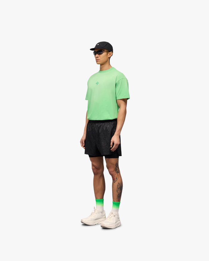 Man wearing black 2-in-1 run shorts on a plain white background | 247 Contour 2-In-1 Run Shorts in Black | Run shorts with inner legging and zip pockets | 247 Shorts | Represent Clo