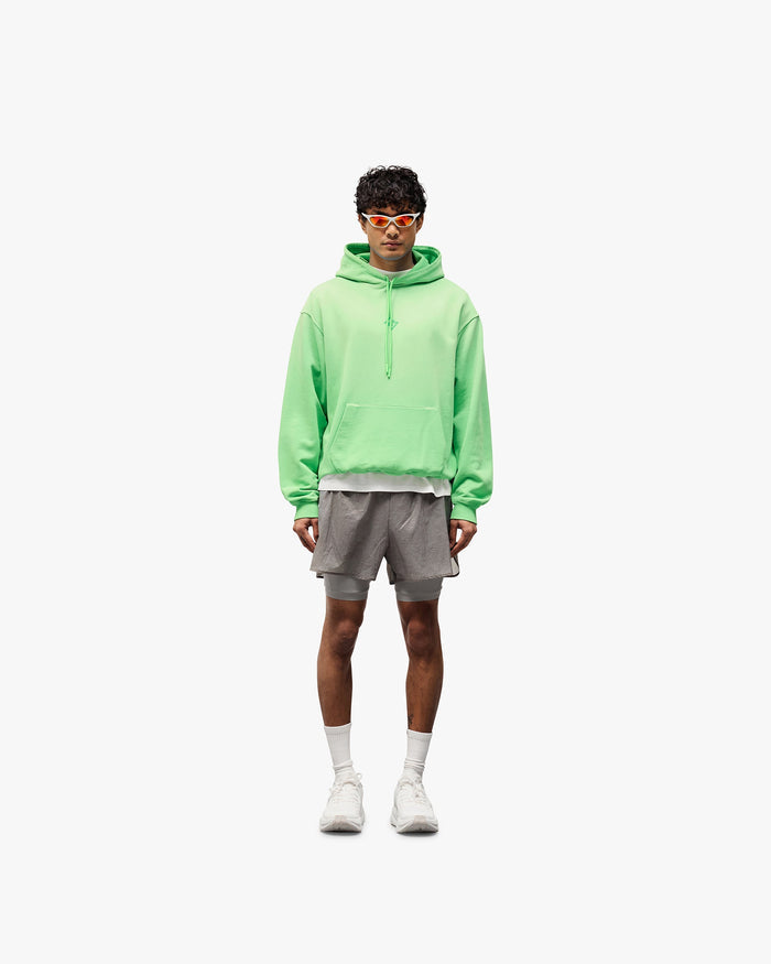 Man wearing grey 2-in-1 shorts on a plain white background | 247 Contour 2-In-1 Run Shorts in Titanium | Shorts with inner legging and side zip pockets | 247 Shorts | Represent Clo
