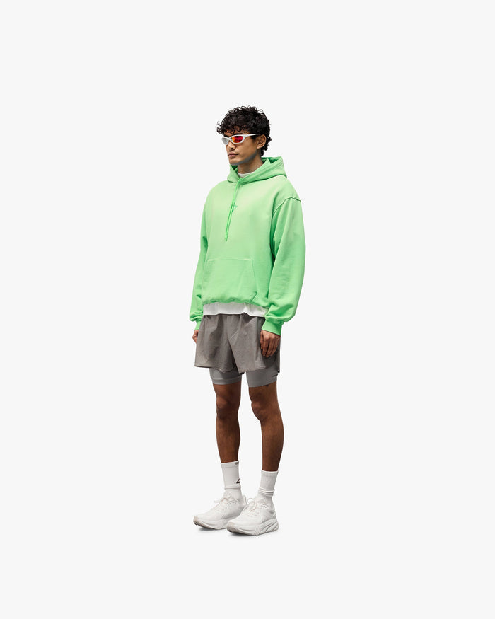 Man wearing grey shorts on a plain white background | 247 Contour 2-In-1 Run Shorts in Titanium | Shorts with inner legging and zip pockets | 247 Shorts | Represent Clo