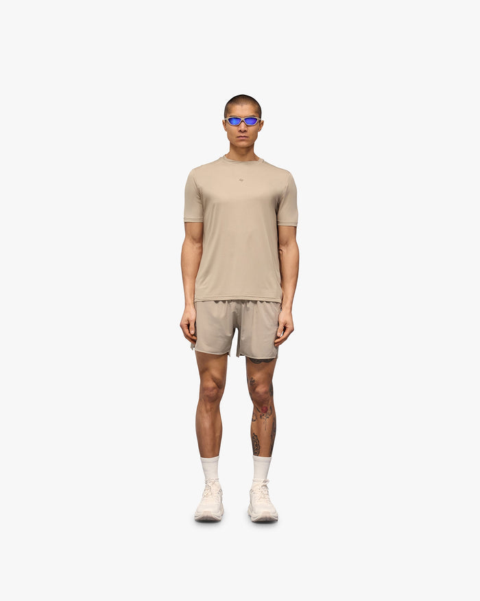 Man wearing a grey technical t-shirt on a plain white background | 247 Contour Run T-Shirt in Pebble | Breathable mesh running t-shirt | 247 T-Shirts | Represent Clo
