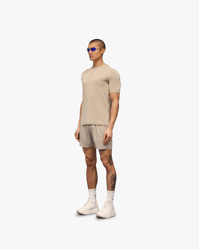 Man wearing a grey t-shirt on a plain white background | 247 Contour Run T-Shirt in Pebble | Breathable, sweat-wicking running t-shirt | 247 T-Shirts | Represent Clo