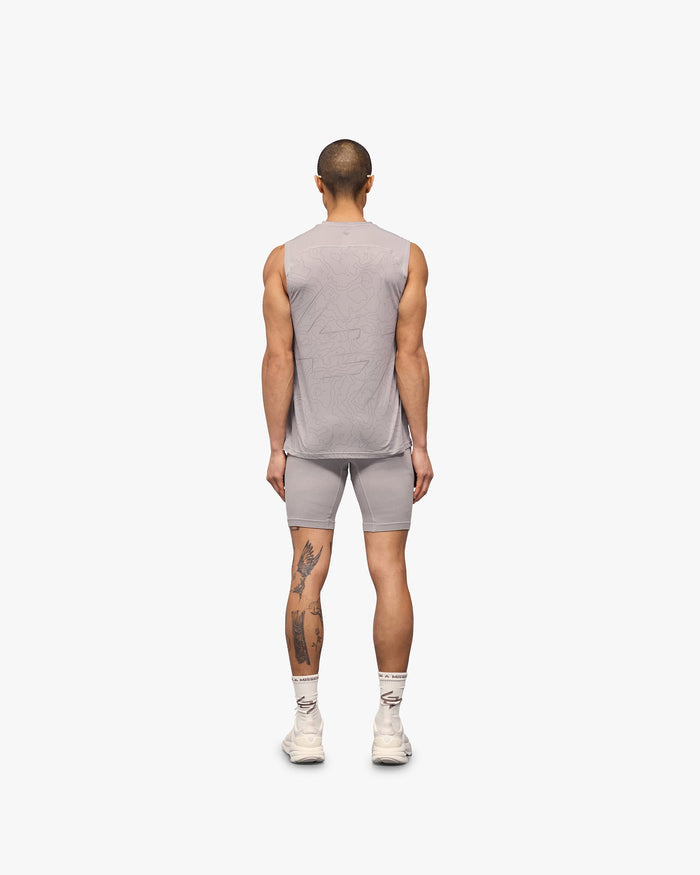 Man wearing a grey running tank on a plain white background | 247 Contour Run Tank in Titanium | Mesh running tank with contour print | 247 T-Shirts | Represent Clo
