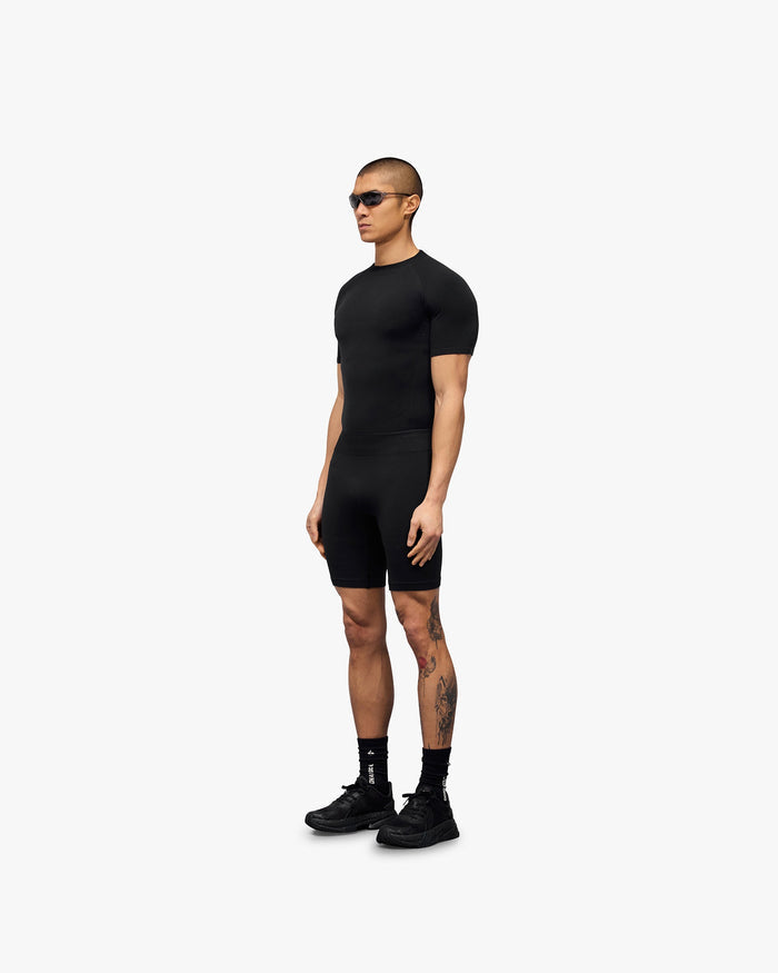 Man wearing black seamless shorts on a plain white background | 247 DNA Seamless Shorts in Black | Seamless shorts with flatlock stitching and compression support | 247 Shorts | Represent Clo