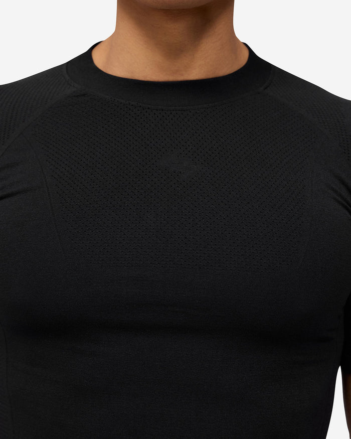 Man wearing a black seamless t-shirt on a plain white background | 247 DNA Seamless T-Shirt in Black | Slim fit t-shirt with engineered knit zones | 247 T-Shirts | Represent Clo