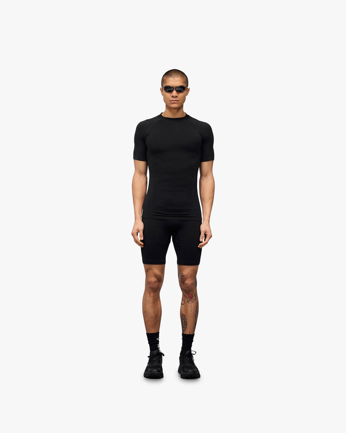 Man wearing a black t-shirt on a plain white background | 247 DNA Seamless T-Shirt in Black | Seamless t-shirt with a slim fit for performance | 247 T-Shirts | Represent Clo
