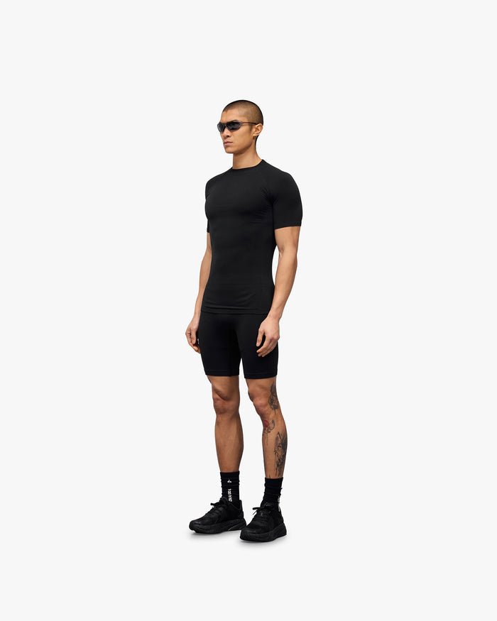 Man wearing a black seamless t-shirt on a plain white background | 247 DNA Seamless T-Shirt in Black | Seamless t-shirt for unrestricted mobility | 247 T-Shirts | Represent Clo