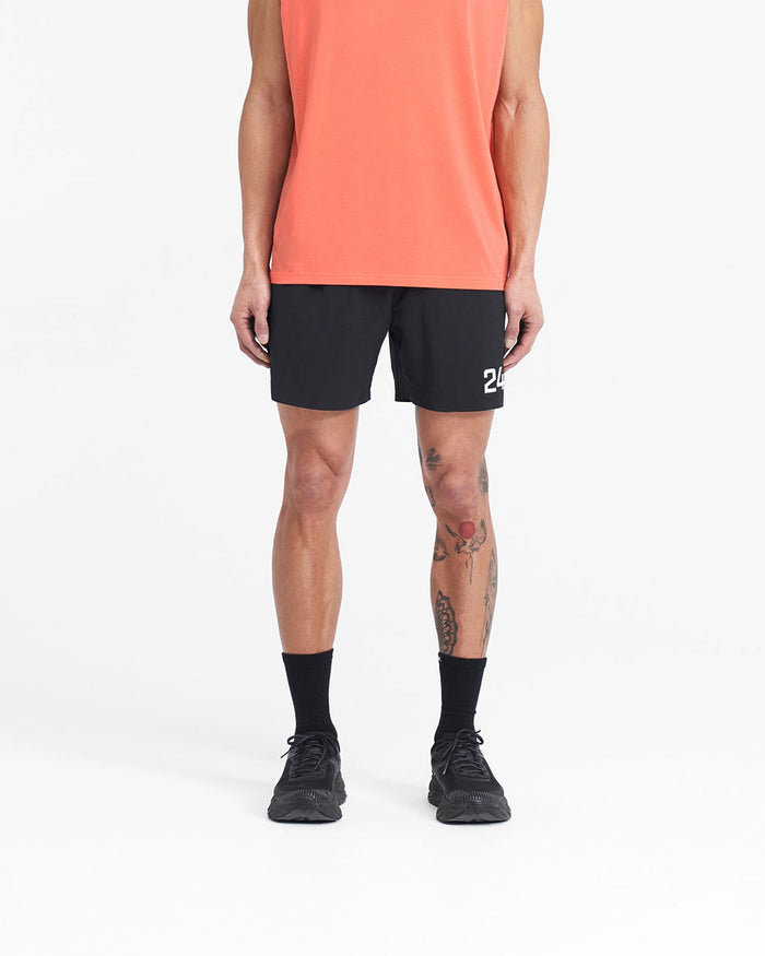 Man wearing black gym shorts on a plain white background | 247 Fused Shorts in Black | Gym shorts with 247 branding and quick-dry fabric | 247 Shorts | Represent Clo