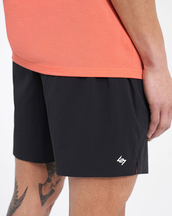 Man wearing black shorts on a plain white background | 247 Fused Shorts in Black | Gym shorts with 247 branded waistband and internal drawcord | 247 Shorts | Represent Clo