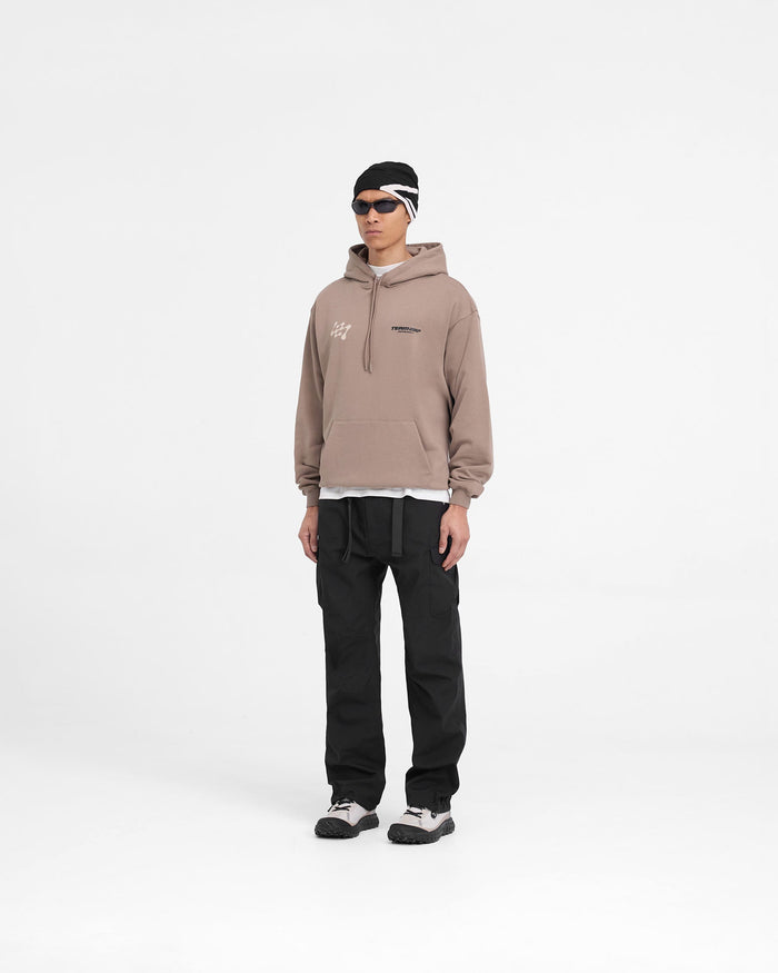 Man wearing a brown oversized hoodie on a plain white background | 247 Future Terrains Oversized Hoodie in Umber | Training hoodie with Future Terrains branding | 247 Hoodies | Represent Clo
