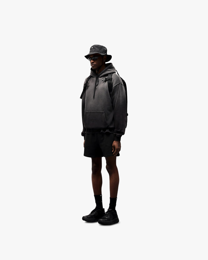 Man wearing an oversized black hoodie on a plain white background | 247 Motion Oversized Hoodie in Black | Oversized hoodie with ribbed hem and 247 motion print | 247 Hoodies | Represent Clo