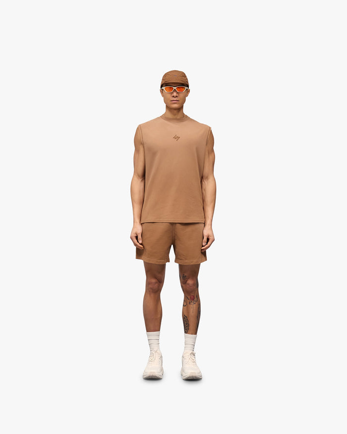 Man wearing rust shorts on a plain white background | 247 Motion Shorts in Rust | Jersey shorts with elasticated waistband and vintage wash | 247 Shorts | Represent Clo