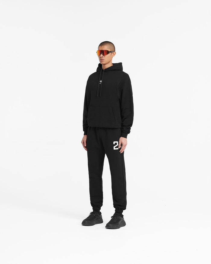 Man wearing a black hoodie on a plain white background | 247 Oversized Hoodie in Jet Black | Oversized hoodie with ribbed cuffs and hem | 247 Hoodies | Represent Clo