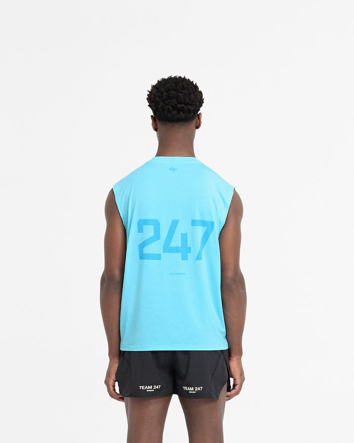 Man wearing a blue tank top on a plain white background | 247 Oversized Tank in Ultra Blue | Oversized tank top with breathable 4-way stretch fabric | 247 T-Shirts | Represent Clo