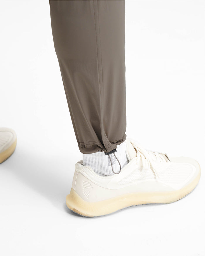 Man wearing mens olive cargo pants on a plain white background | 247 Pant in Olive | Lightweight pants with zip side pockets and adjustable hem | 247 Pants | Represent Clo