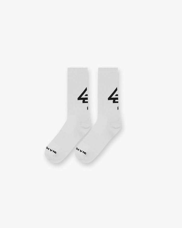 Back product image of a mens white sock with black logo on a plain white background | 247 Race Sock in White | Lightweight breathability and snug fit socks | 247 Accessories | Represent Clo