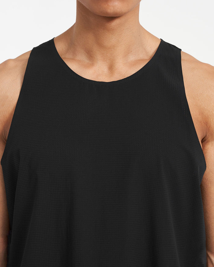 Man wearing a black training vest on a plain white background | 247 Singlet in Jet Black | Perforated singlet with bonded hems | 247 T-Shirts | Represent Clo