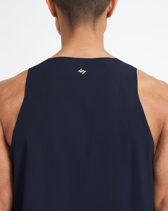 Man wearing a navy singlet on a plain white background | 247 Singlet in Navy | Training vest with stretch ripstop fabric and bonded hems | 247 T-Shirts | Represent Clo