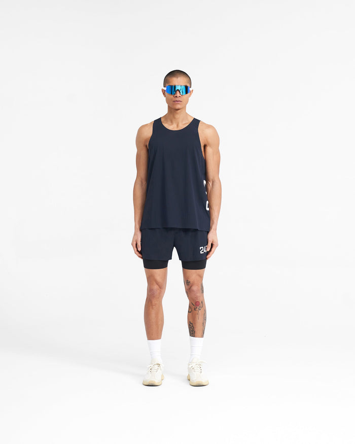 Man wearing a navy training vest on a plain white background | 247 Singlet in Navy | Perforated singlet with stretch ripstop fabric | 247 T-Shirts | Represent Clo