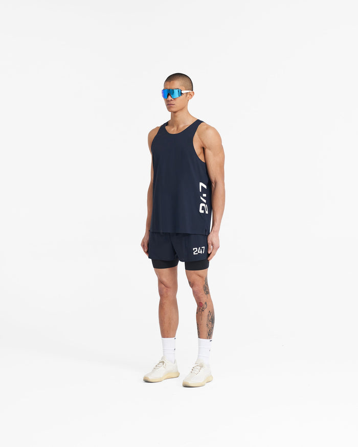 Man wearing a navy singlet on a plain white background | 247 Singlet in Navy | Performance vest with 4-way stretch and flatlock seams | 247 T-Shirts | Represent Clo