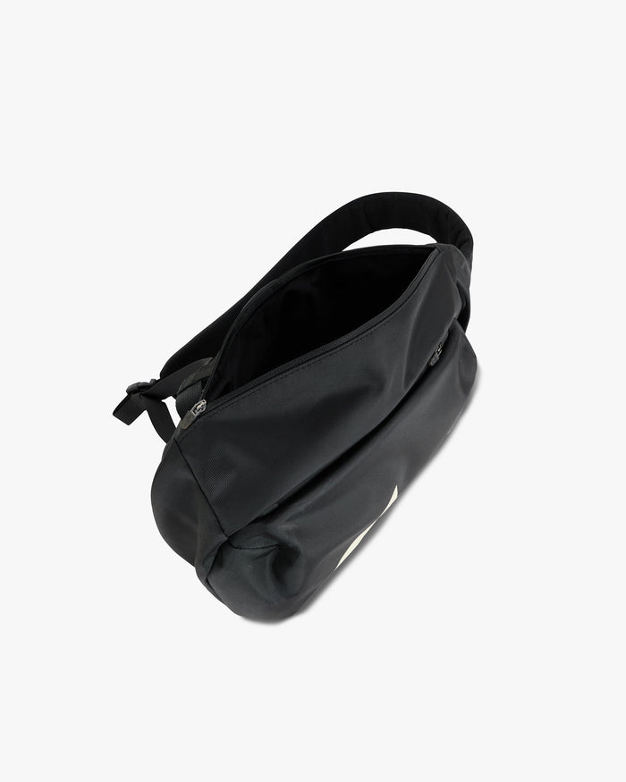 Product image of a black sling bag on a plain white background | 247 Sling Bag in Black | Sling bag with 2 zip pockets and adjustable padded strap | 247 Accessories | Represent Clo