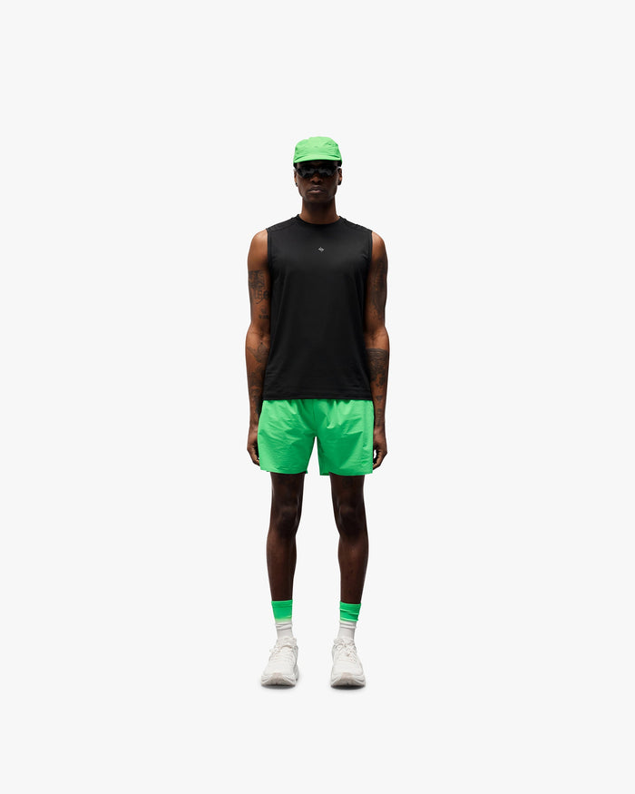 Man wearing green shorts on a plain white background | 247 Training Shorts in Speed Green | Training shorts with breathable perforation and zip pockets | 247 Shorts | Represent Clo