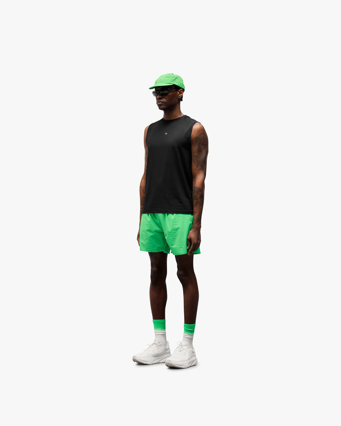 Man wearing green shorts on a plain white background | 247 Training Shorts in Speed Green | Nylon spandex blend shorts with zip pockets | 247 Shorts | Represent Clo