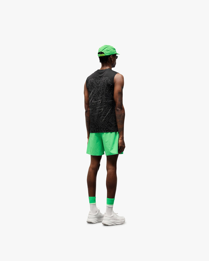 Man wearing green shorts on a plain white background | 247 Training Shorts in Speed Green | Nylon spandex shorts with perforation detailing | 247 Shorts | Represent Clo