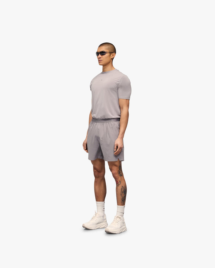 Man wearing grey shorts on a plain white background | 247 Training Shorts in Titanium | Nylon and spandex shorts with breathability | 247 Shorts | Represent Clo