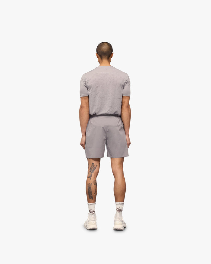 Man wearing grey training shorts on a plain white background | 247 Training Shorts in Titanium | Flexible nylon and spandex blend shorts | 247 Shorts | Represent Clo