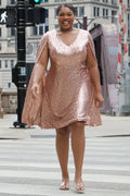 Sydney's Closet CE2609 in rose gold.

Plus size sequin rose gold metallic short party dress. V-neckline, bra-friendly straps with attached cape sleeve detail, princess silhouette, slim A-line skirt. at knee-length.