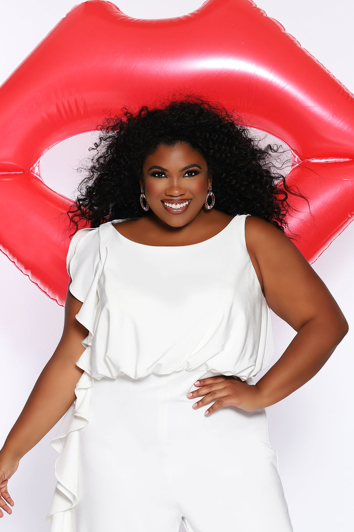 CE2014 by Sydney's Closet french crepe fabric jumpsuit with flounce on side of bodice and pant with center back zipper and scoop neckline, bra friendly straps and sleeveless available in red, black and ivory.