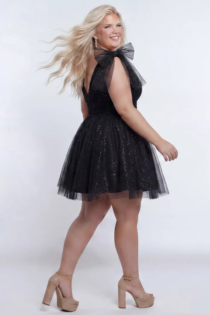 Short A-line plus size flowy party dress SC8153 by Sydney's Closet in the color Onyx black. Back view. Layers of dense sparkle tulle and a satin lining. V-neckline with thick bra-friendly straps and detachable bows at the top of the shoulder. Pleated bodice and 3 inch pleated waistband. Pockets and long invisible center back zipper. Available in Shamrock green, Admiral blue, Firecracker red and Shamrock green in sizes 14-32. Model is 5'9.
