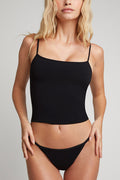 Black cotton bra cami with thin straps, fitted bust, and straight hem