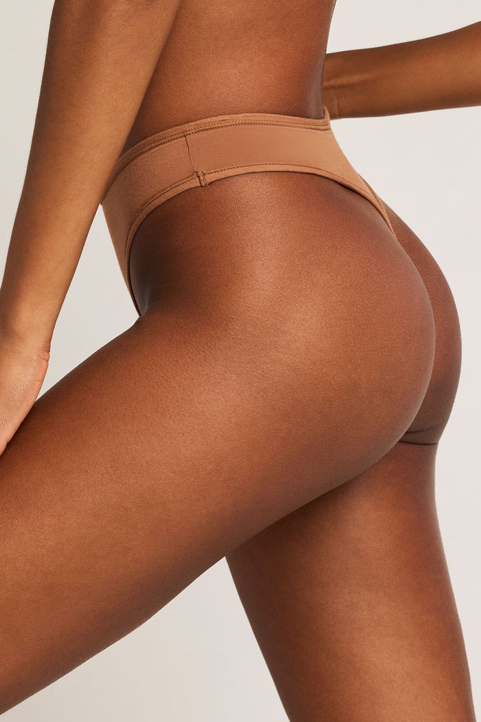 Cotton thong in deep brown, back view with wide elastic waistband and narrow back