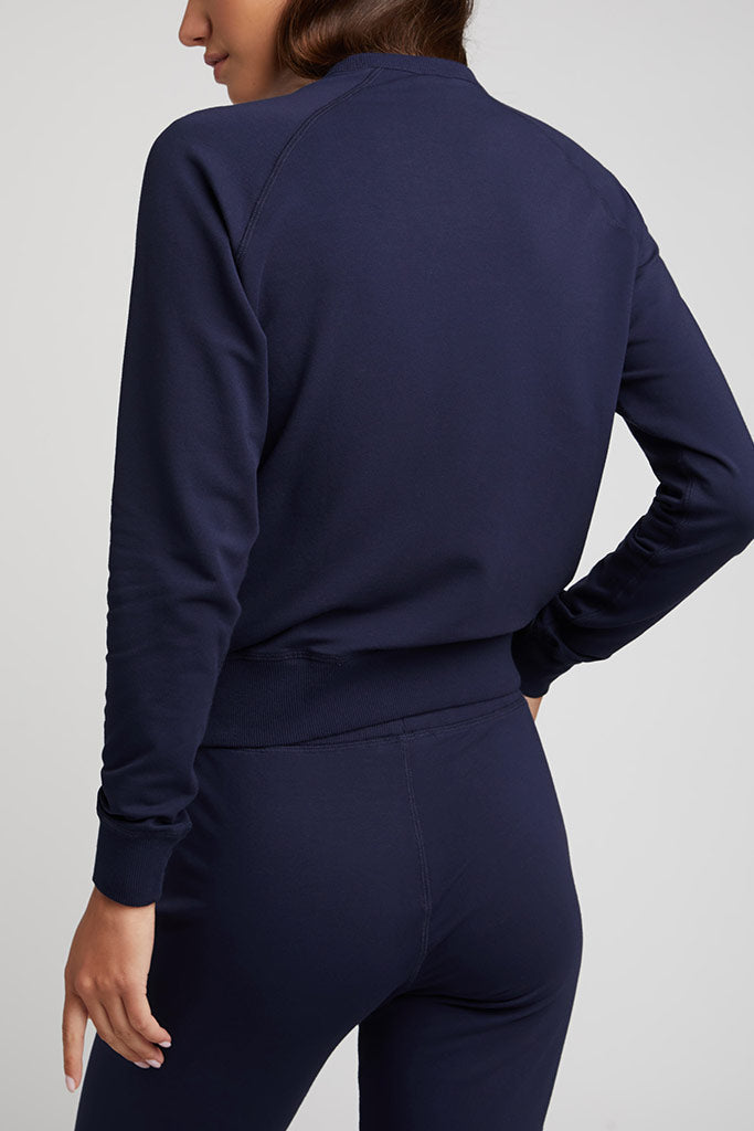 Navy crewneck sweatshirt back view with jogger pants, ribbed cuffs and drawstring waist