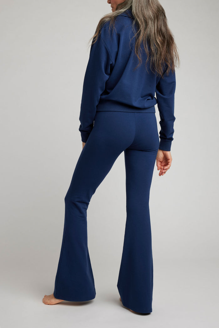 Navy flare pants with full-length bootcut silhouette and smooth leg panels