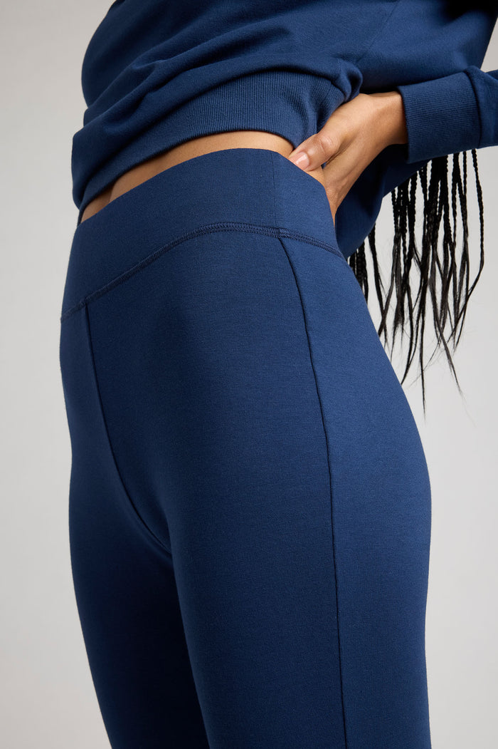 Navy flare pant back view with curved yoke seam and smooth fabric panels