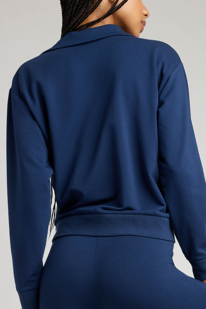 Navy long-sleeve collared pullover, back view, relaxed straight hem