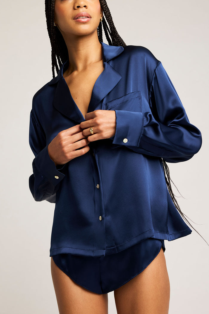 Navy button-up shirt with pointed collar, long sleeves, and front placket